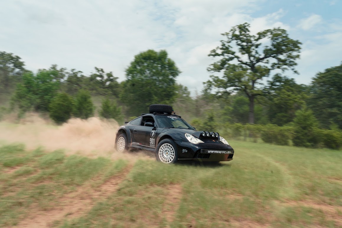 Black 911 Heritage RX charging through dust on a Texas trail