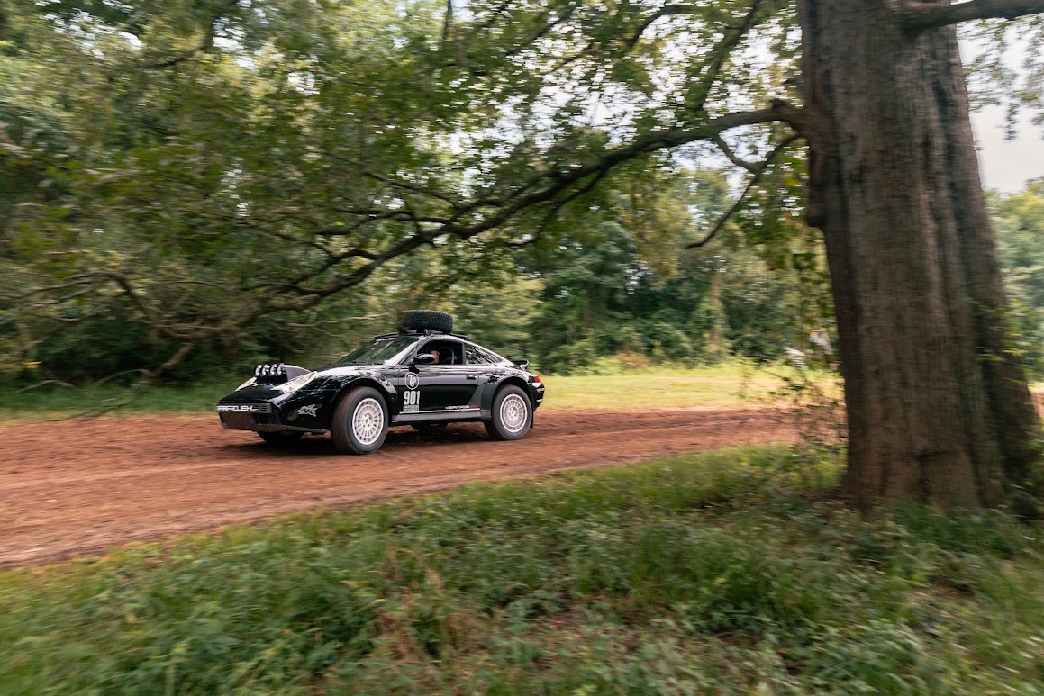 Black 911 Heritage RX moving through a wooded Texas landscape