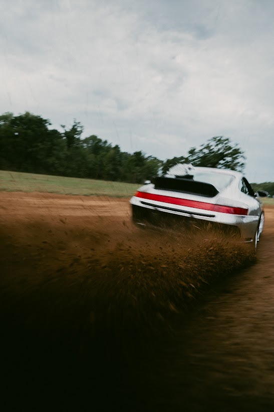 Silver 911 Safari RS throwing dirt on a ranch trail at The Creek Place