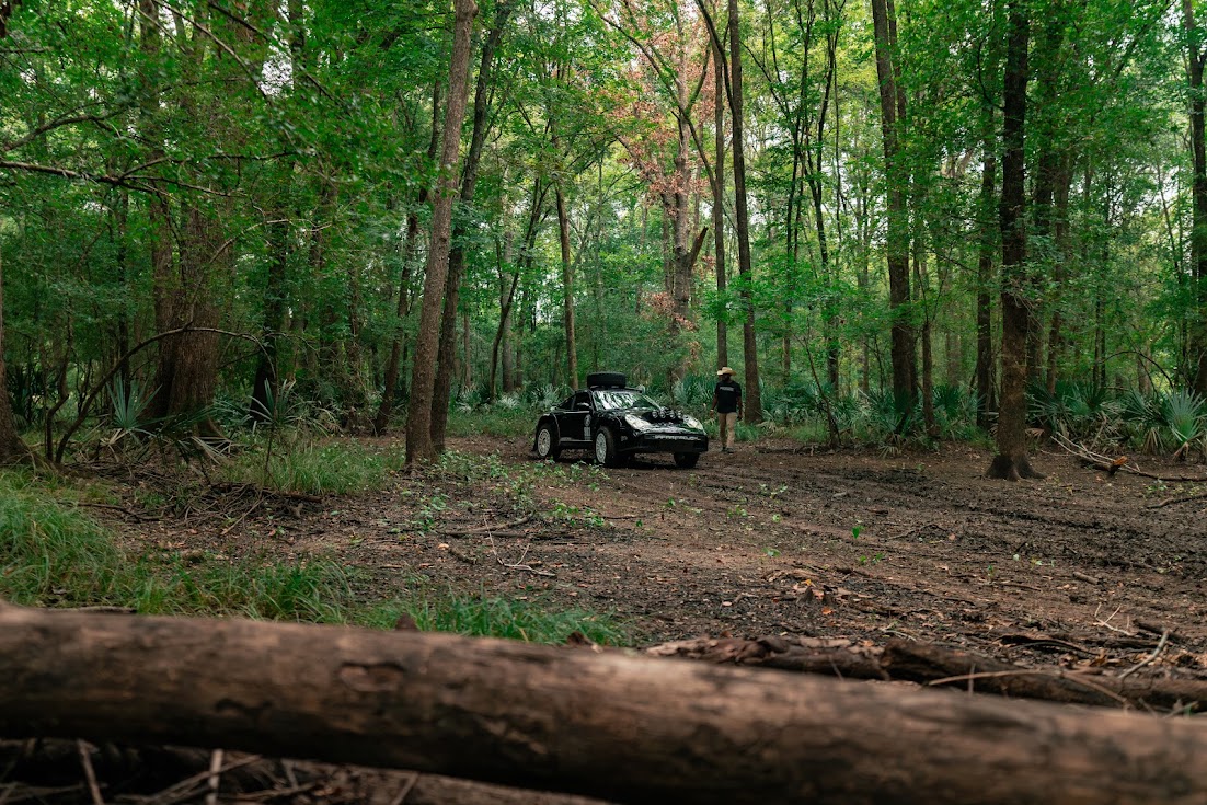 The 911 Heritage RX parked on a forest two-track surrounded by tall East Texas timber